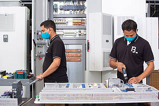 Two employees in the in-house switchgear construction in India